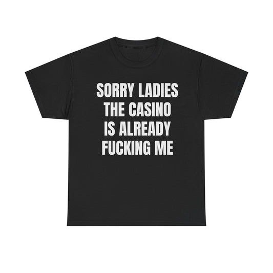Black crew neck t-shirt with the text 'SORRY LADIES THE CASINO IS ALREADY FUCKING ME' printed in white.