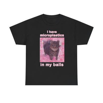 This image features a black crew neck t-shirt with a bold, humorous print. The front of the shirt displays a graphic with the phrase "I have microplastics in my balls" in white text, positioned over a vivid pink background that adds a striking contrast.