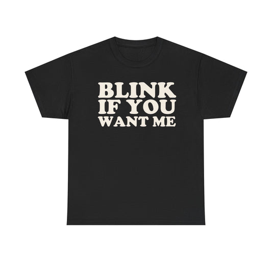 A black crew neck t-shirt with the text 'BLINK IF YOU WANT ME' printed in white on the front.